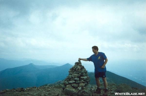 Putting the tip on a cairn at the summit of MT Lafayette.
