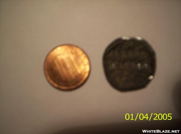 Burnt penny next to unburnt penny