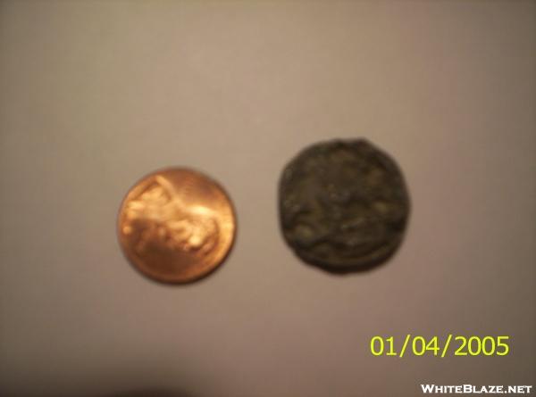 Burnt penny next to unburnt penny